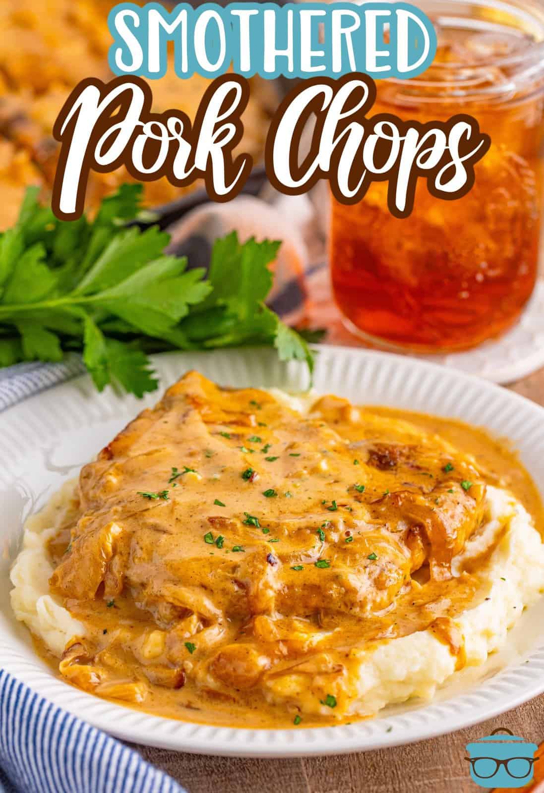 A plate with mashed potatoes and Smothered Pork Chops. 