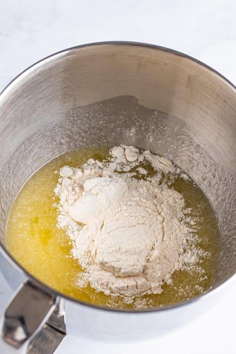 Flour being added to the wet ingredients.