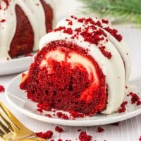 A slice of Red Velvet Cheesecake Bundt Cake sitting on a plate.