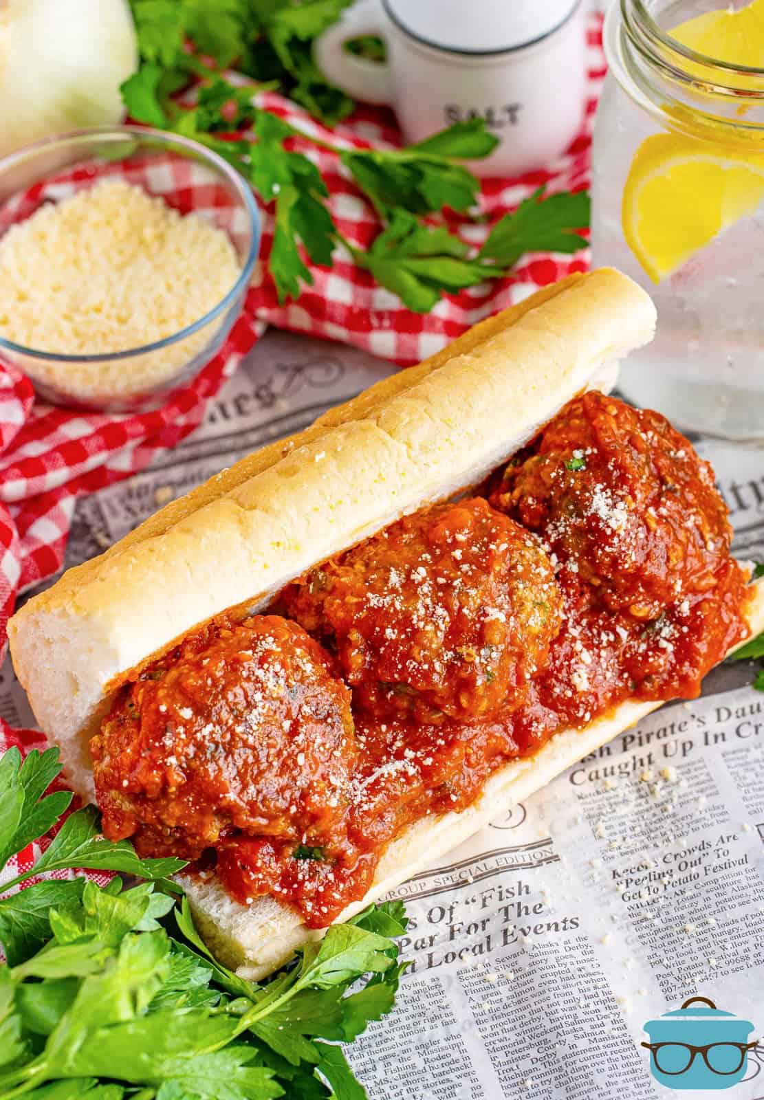 A sub roll with three large Homemade Meatballs and sauce.