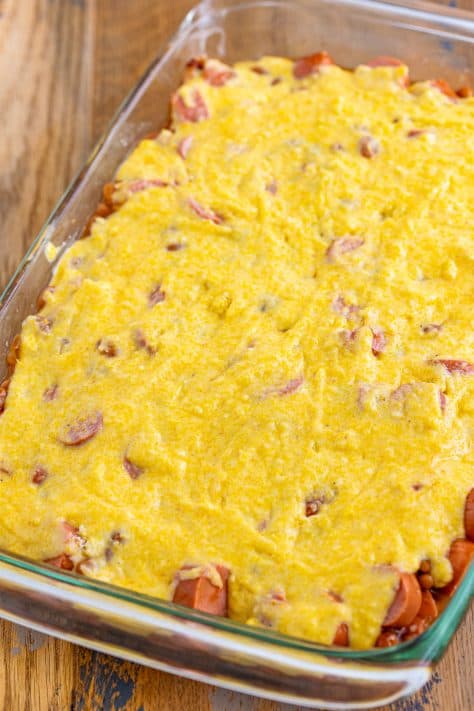 Cornbread mixture on top of bean and hot dog mixture.