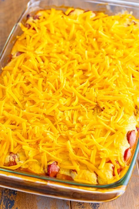 Cheese on top fo Beanie Weenie Casserole in a baking dish.