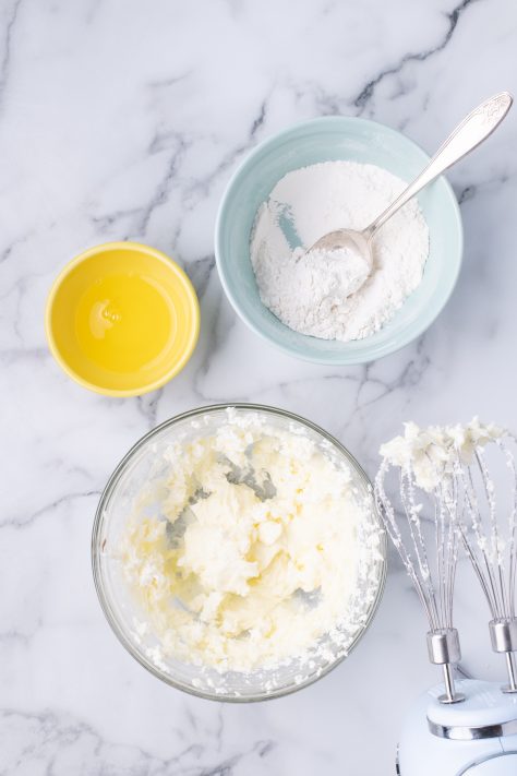 Cream cheese, sugar, and flour in a mixing bowl.