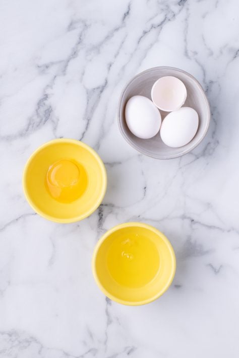 Small bowls with egg yolks and egg whites.