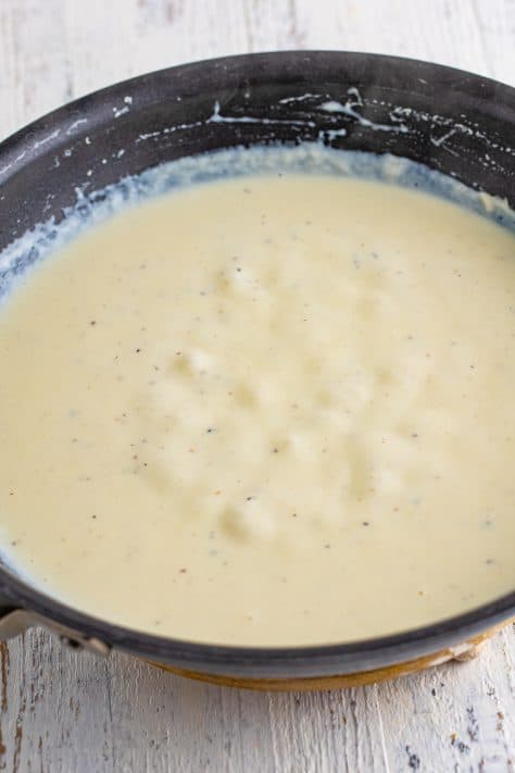 Melted butter, salt, pepper, and flour making a thick sauce in a saucepan.