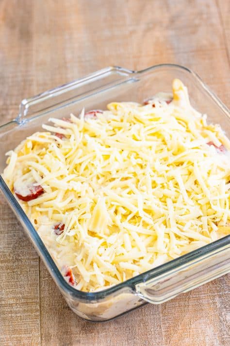 Polish casserole for two in a baking dish with mozzarella cheese on top.
