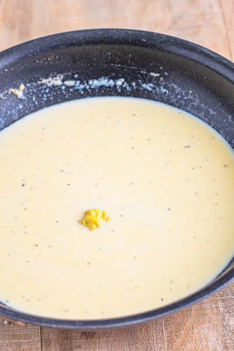 Thickened sauce for a Polish Casserole in a skillet.