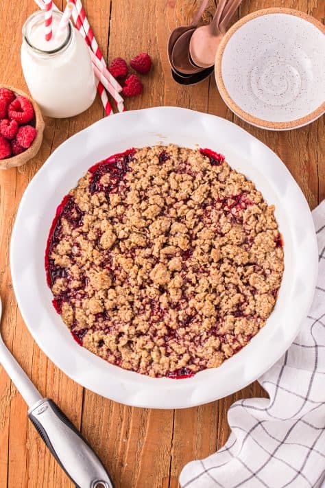 A freshly baked Raspberry Crumble in a pie plate.