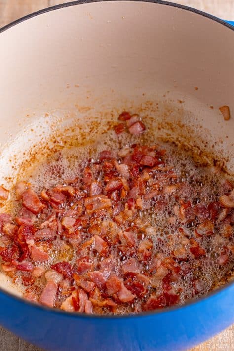 Cooked bacon and bacon fat in a Dutch Oven.