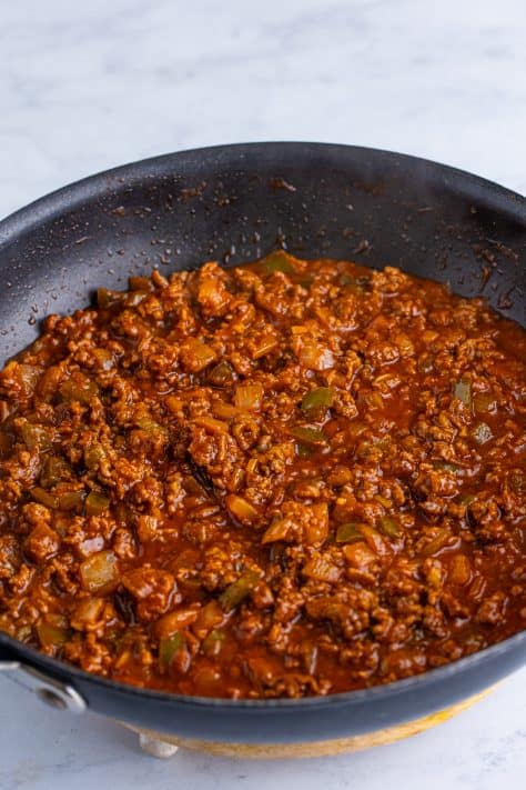 Simmered sloppy joe meat in a skillet.