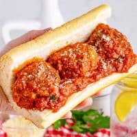 A sub roll with Homemade Meatballs and sauce on it.