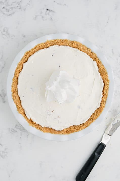 Whipped topping spread out over the pie filling.
