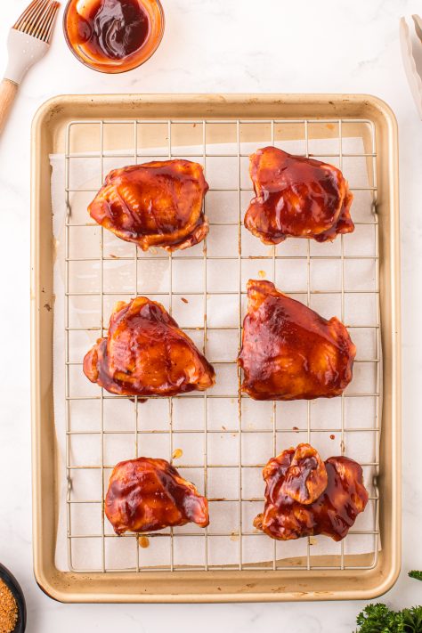 BBQ sauce covered chicken thighs.