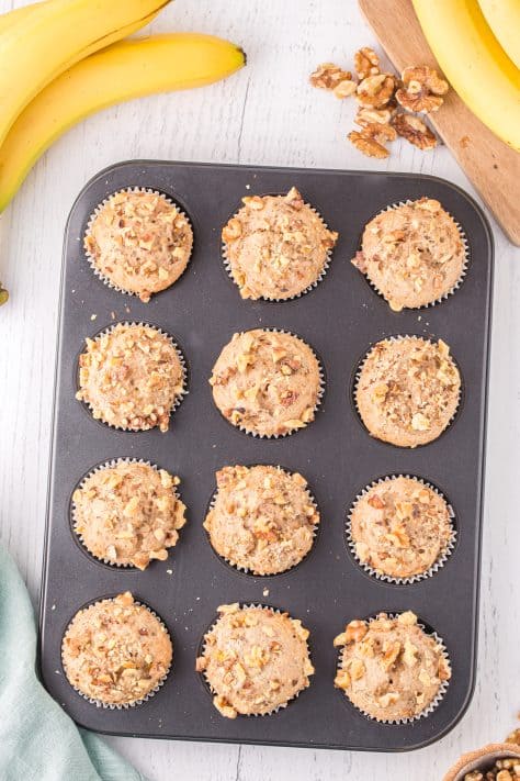 Fresh baked Banana Nut Cake Mix Muffins in the muffin tin cooling.