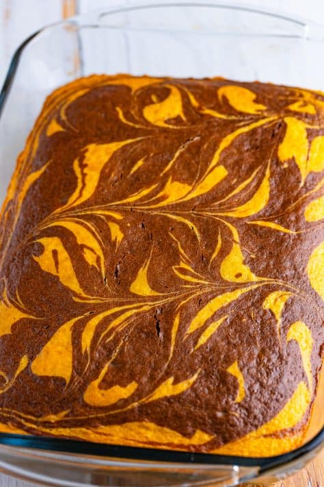 A freshly baked marbled cake in a glass dish.