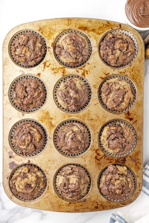 Baked banana nutella muffins in a muff tin.