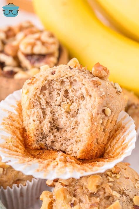 A Banana Nut Cake Mix Muffin with the wrapper peeled down and a bite missing.