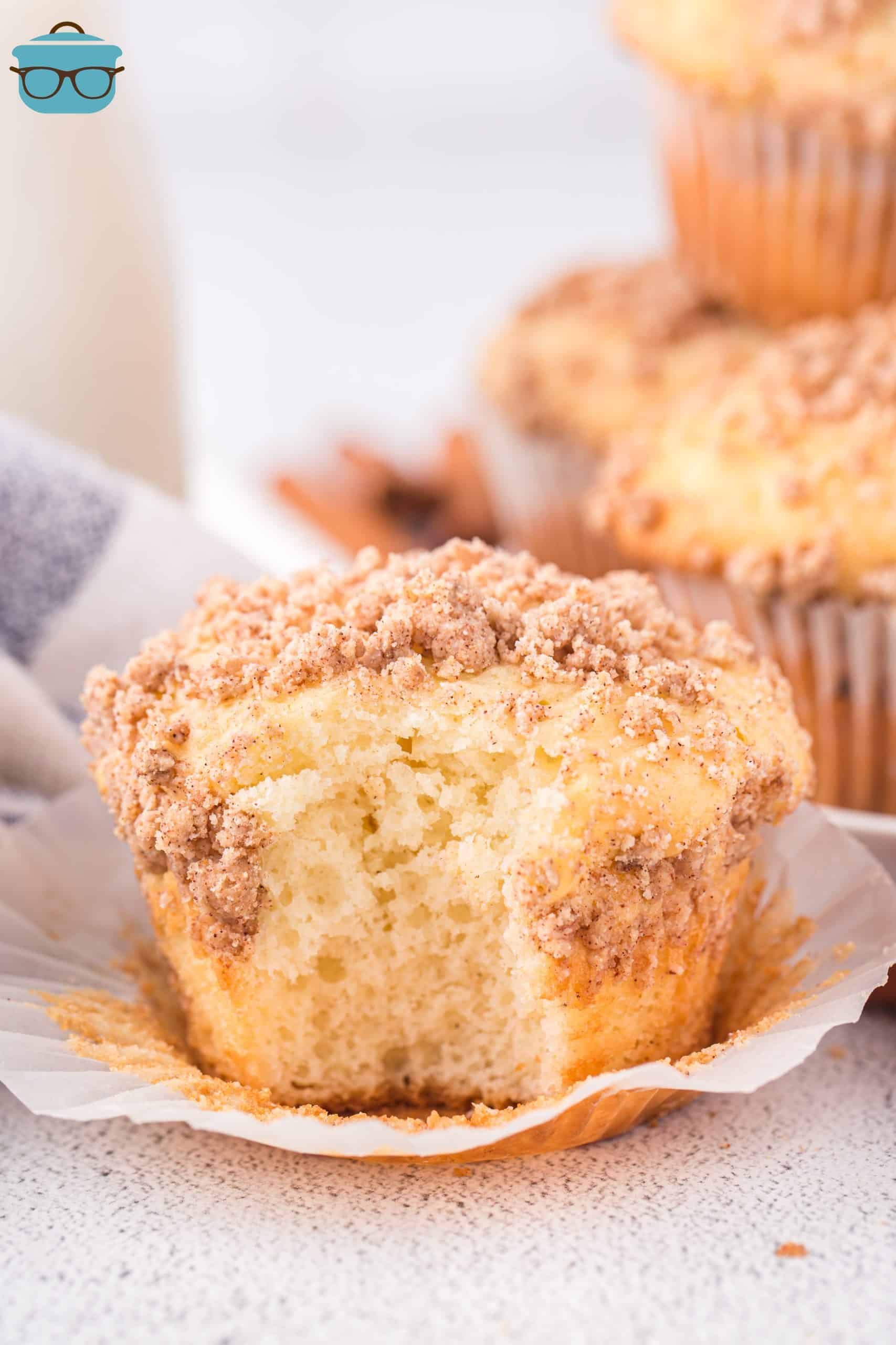 A Cinnamon Streusel Cake Mix Muffin with a bite missing.