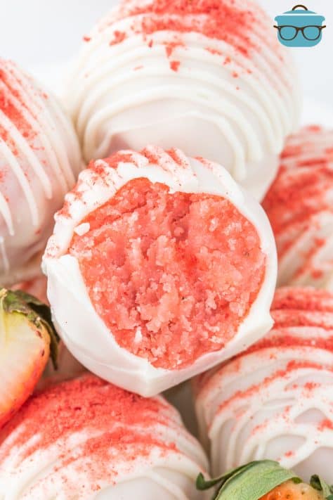 An open Strawberry Cake Ball sitting with a few others.