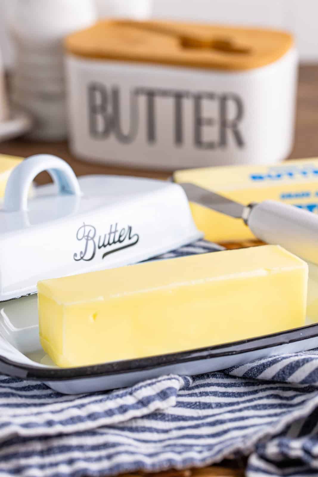 A stick of butter sitting in a butter tray.