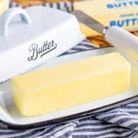 A softened stick of butter on a butter tray.