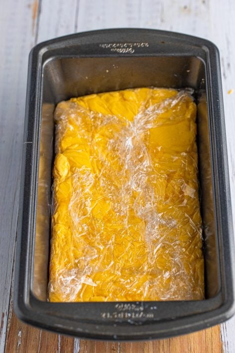 plastic wrapped homemade Velveeta in a loaf pan.