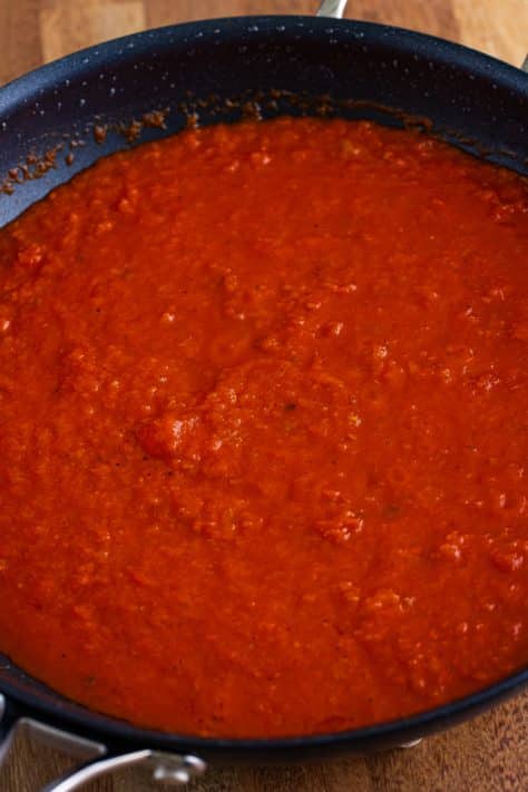 A skillet of marinara sauce.