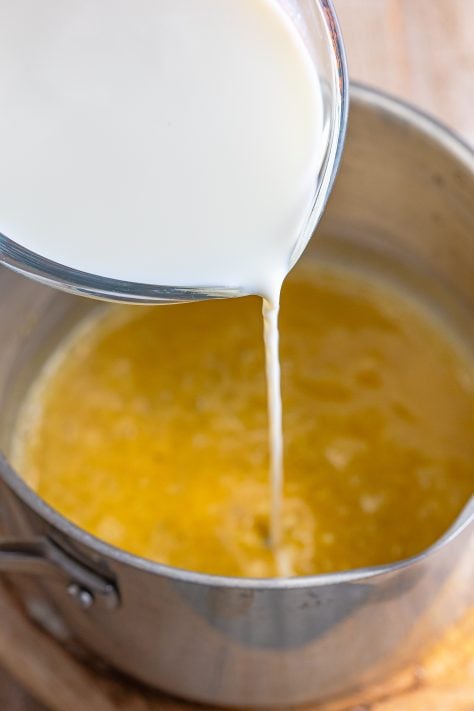 Milk being poured into the butter mixture.