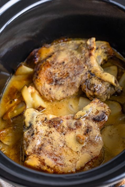 Cooked pork chops with gravy for two in a slow cooker.