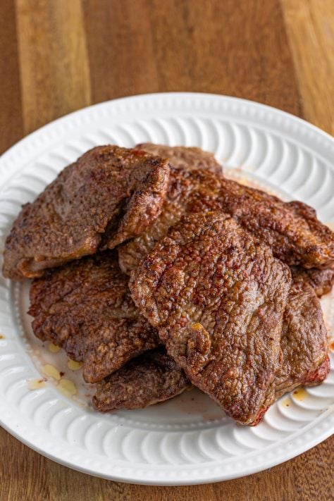 Seared steaks on a plate.