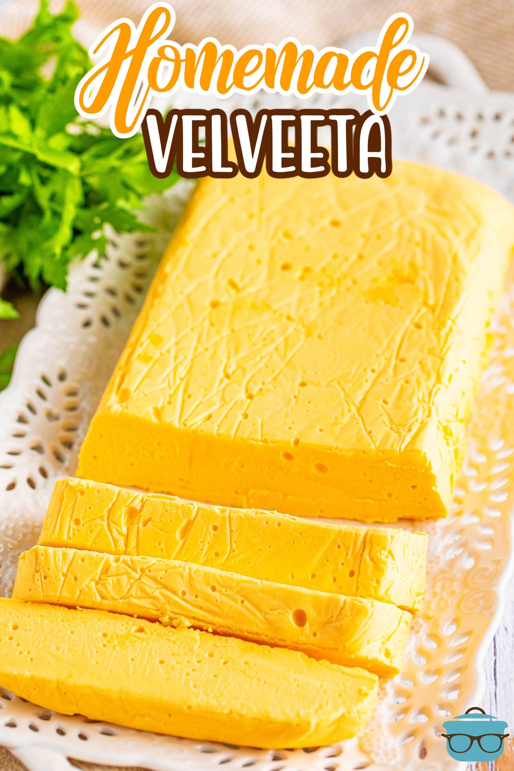A large loaf of Homemade Velvetta Cheese with a few chunks sliced off.