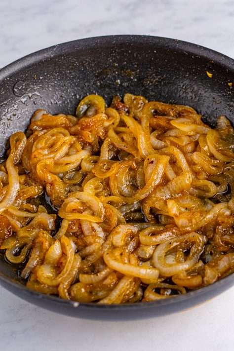 A skillet with cooked down onions.