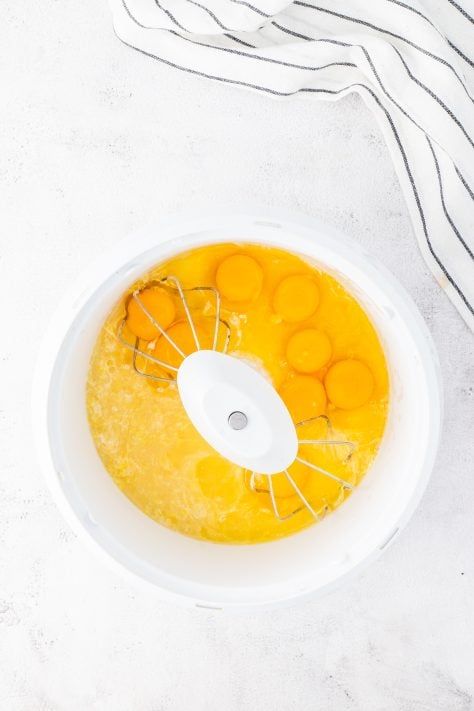 Lemon juice and eggs being mixed into dry ingredients.