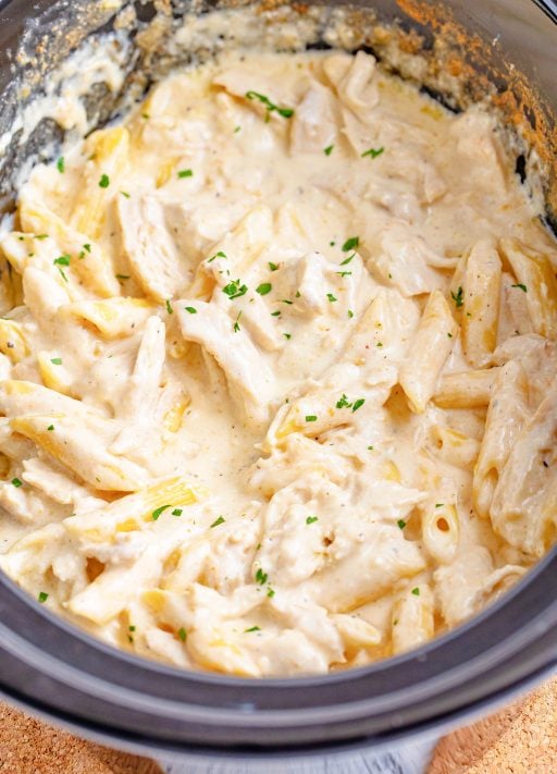Penne pasta with Alfredo and chicken in a crock pot.