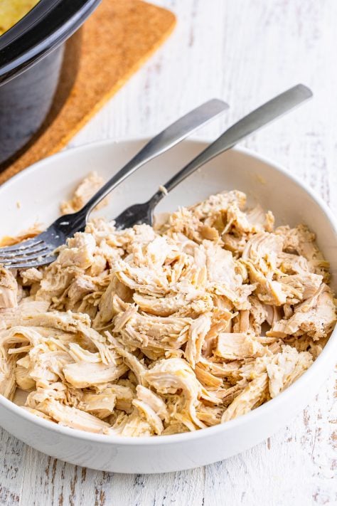 A bowl with shredded chicken.