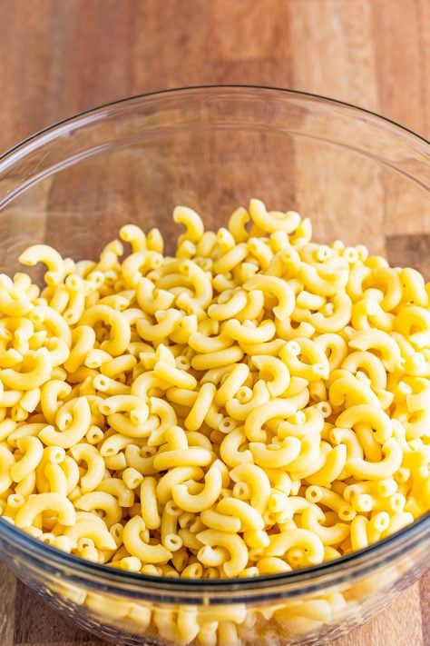 cooked macaroni noodles in a large clear bowl.