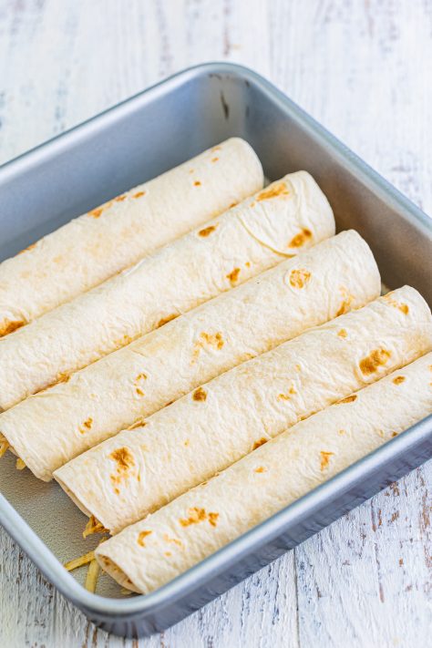 wrapped chicken tortillas in a baking dish.