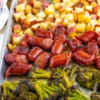 Close up looking at the broccolini, potatoes, and kielbasa for this sheet pan dinner.
