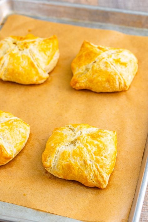 fully baked chicken wellingtons on a baking sheet.