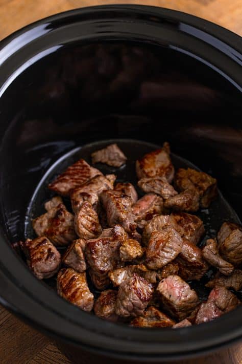 browned stew meat in a Crock Pot.