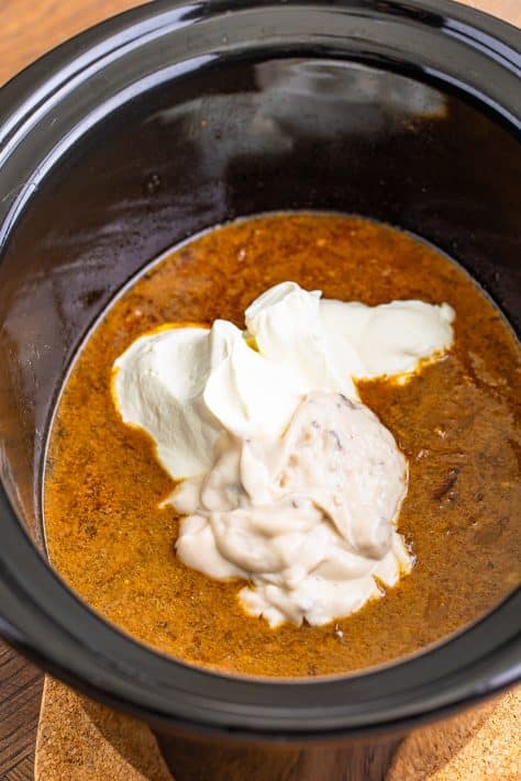 A dollop of sour cream and cream of mushroom soup on top of beef and gravy.