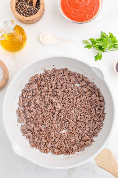 Ground beef in a skillet.