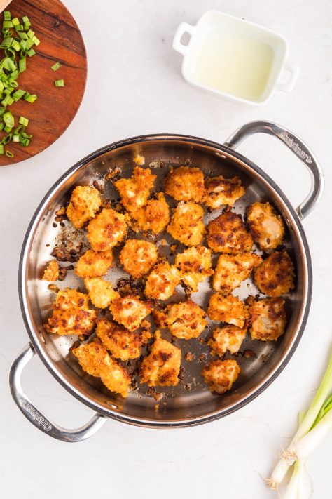 Chicken cooking in a skillet.