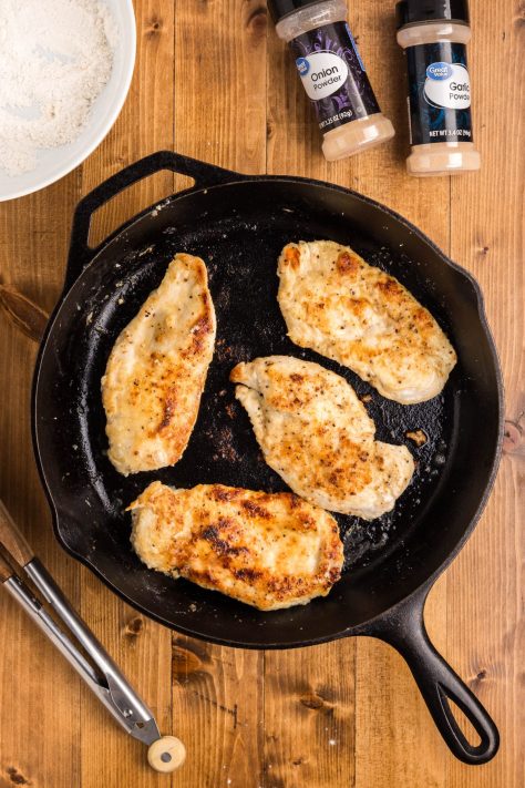 Chicken cooking in a skillet.