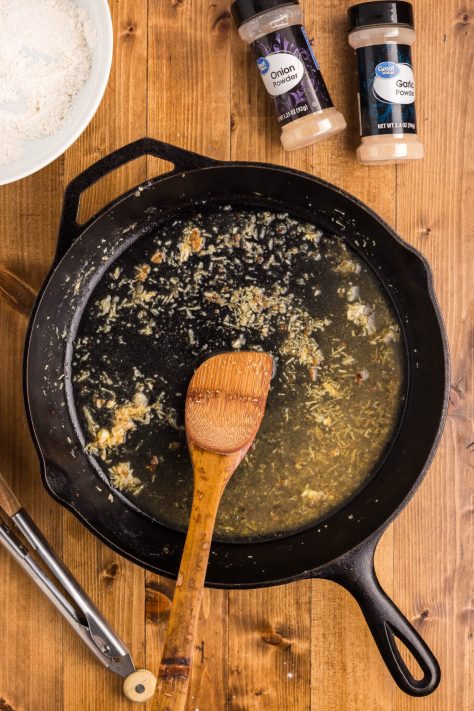 White wine, broth, and minced garlic in a skillet.