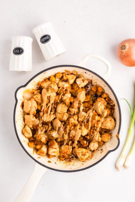 Chipotle sauce being added to a skillet.
