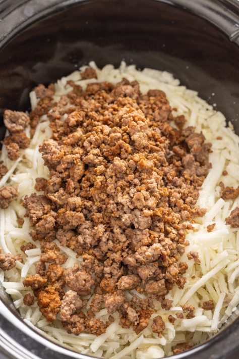 Shredded hash browns and taco meat in a Slow Cooker.