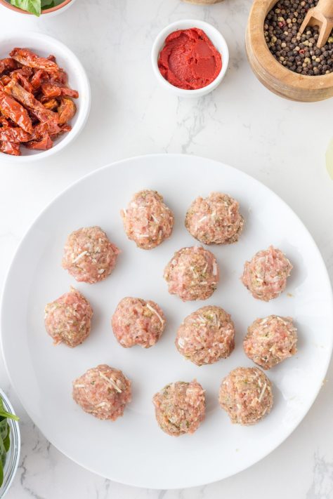 Raw meatballs on a plate.