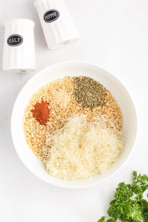 A bowl of breadcrumbs and seasonings.