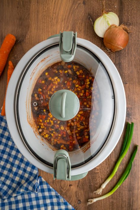 A lid covering a Slow Cooker with lazy enchiladas.